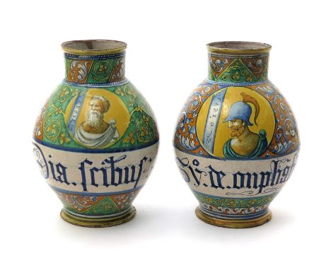 A pair of Faenza maiolica albarelli  mid 16th century, the large baluster forms painted with portraits of bearded men on a ye