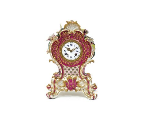 An English porcelain clock case  early 19th century, probably Coalport, of elaborate rococo form, the sides pierced and appli