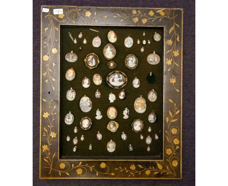  A frame containing approximately 54 cameos, eleven in gilt metal settings, including the three graces, and many fine carved 