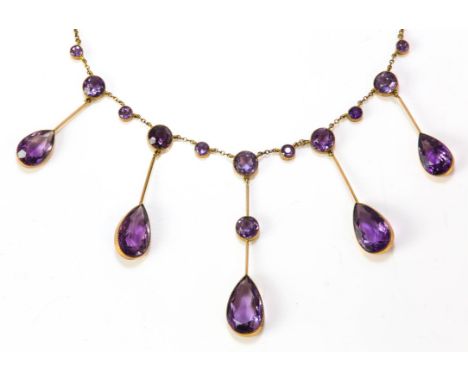Amethyst fringe necklace, five integrated, graduated drops of pear cut amethysts, spaced with round cut amethysts on a stampe