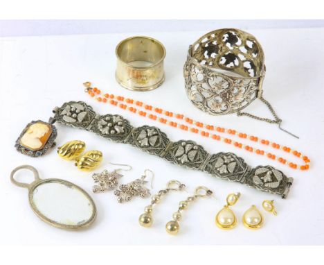 Selection of silver jewellery, including a large openwork bangle, two pairs of earrings, a napkin ring, and a small mirror, t