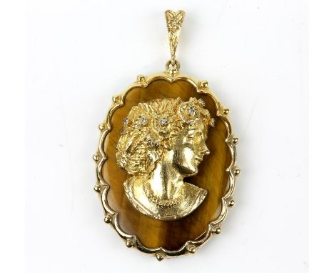 Tigers eye cameo pendant, oval tigers eye, set with an applied gold profile of a lady, wearing a diamond set head piece, and 