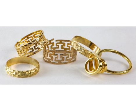 Five rings, including two matching engraved band rings in 9ct, one size L and one size M, an openwork band ring stamped 14k, 