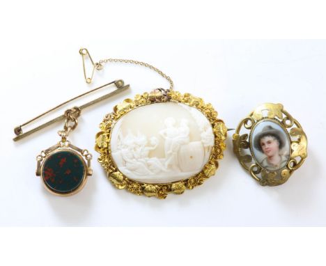 Three brooches, including a cameo brooch in tested 9ct, a miniature portrait brooch, in base metal, and a carnelian and blood
