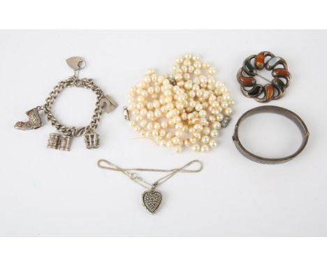 Selection of jewellery including an engraved clasp bangle hallmarked Chester 1949, a charm bracelet with four charms and a he