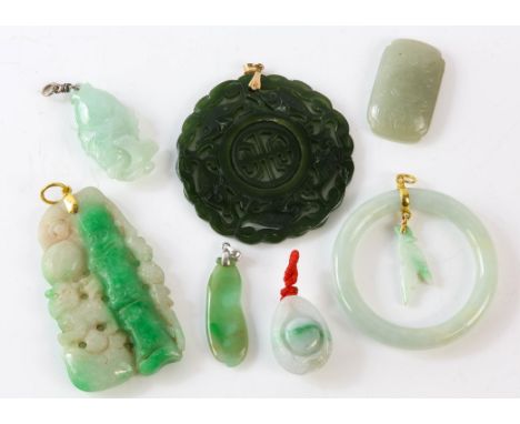 A group of five carved jade pendants and two other carved jade items, including one nephrite fish pendant, bail stamped 18ct,