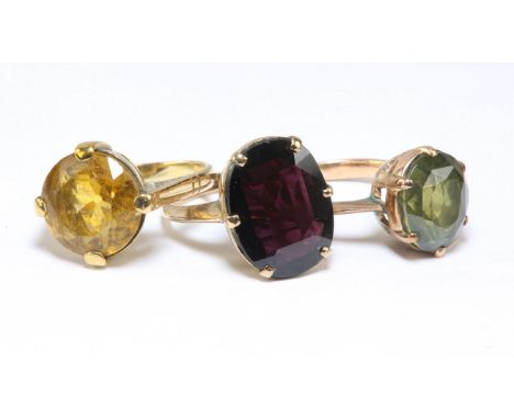 Three gem set rings, including a single stone green zircon ring, in tested 9ct, size L, a single stone garnet ring, and a sin