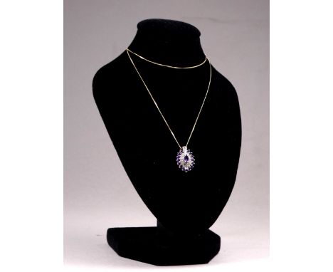 A 9ct yellow gold amethyst and diamond pendant - navette shaped and on a fine 9ct yellow gold chain, weight 2g.