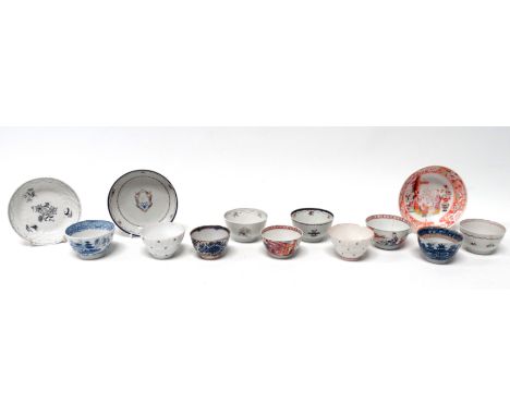 A late 18th century tea bowl and saucer - decorated with family armorial, together with two further tea bowls and saucers and
