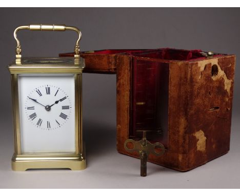 A 20th century carriage clock - the corniche case bearing presentation name and with a white enamel dial set out in Roman num