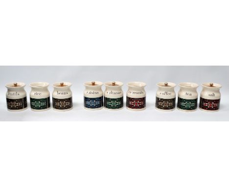 A set of nine Hornsea style kitchen canisters - decorated with an Aztec pattern on a cream ground and bearing a variety of co