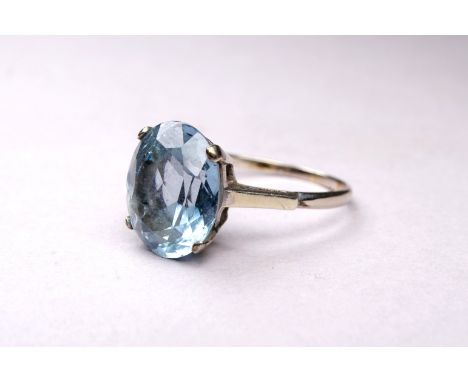 A 9ct white gold aquamarine ring - the oval cut stone with a claw setting, ring size T, weight 4.5g.