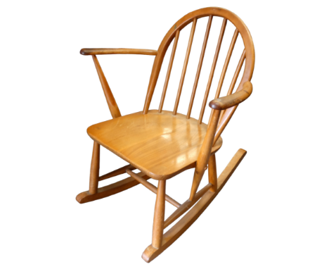 An Ercol elm and beech child`s rocking chair - with a spindle back and solid seat, on turned supports and rockers, trade labe