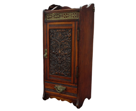 A late Victorian walnut and oak smoker's cabinet - with brass gallery above a carved panel door and drawer, the interior fitt