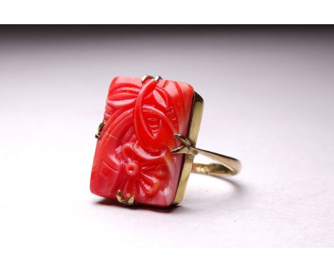 A 9ct yellow gold coral plaque ring - carved with a flower, size Q, weight 3.8g.