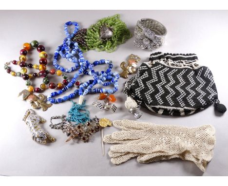 A small quantity of costume jewellery - including a bead purse bag, a rhinestone set bangle and sundry bead necklaces.