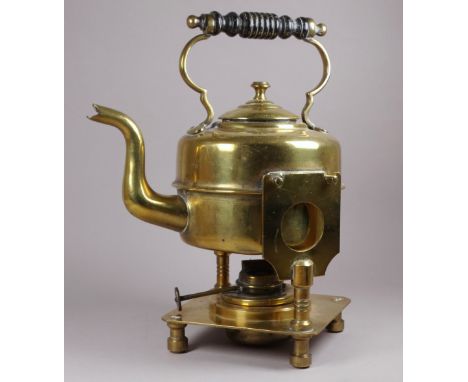 An Art Nouveau style brass spirit kettle and stand - with a turned ebonised handle, the square base raised on turned feet, he