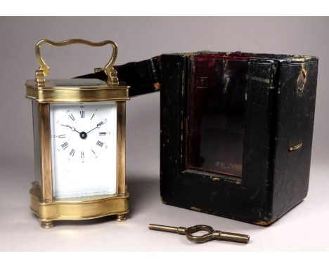 A 20th century carriage timepiece - with an ogee shaped case fitted with a white enamel dial set out in Roman numerals, heigh