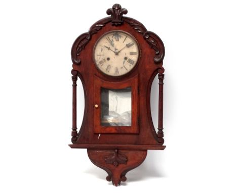 An early 20th century walnut cased American wall clock - the leaf carved case with glazed panel door and mirror behind, the c