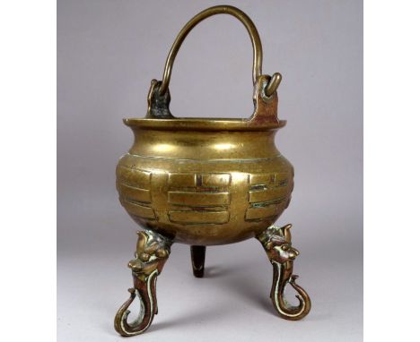 A late 19th century Chinese brass censer - of cauldron form with hoop handle and raised on three trunk feet with monkey masks