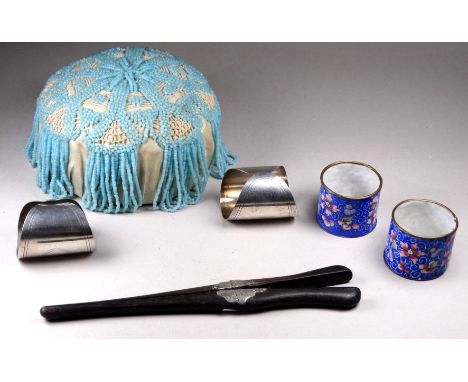 A pair of white metal napkin rings - with vacant cartouches, together with a pair of Chinese enamel napkin rings, a pair of g