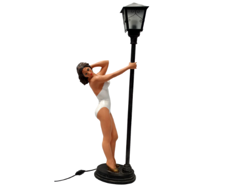 A 20th century cast resin table lamp - modelled as an exotic lady in white swimsuit below a street light, height 86cm.