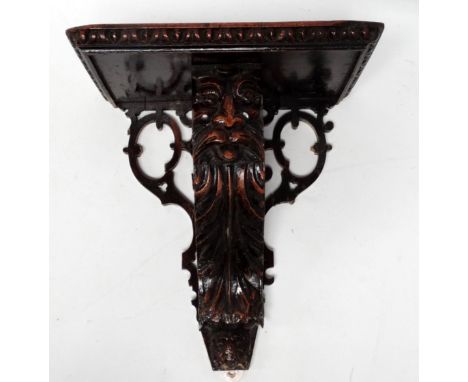 A late Victorian carved walnut wall bracket - in the Jacobean style, the rectangular shelf with a scroll support incorporatin