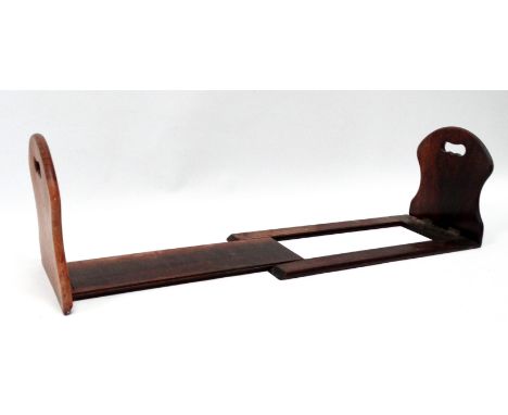 A late 19th century rosewood book trough - the shaped sliding hinged ends pierced with hand holds, branded GWD to base, width