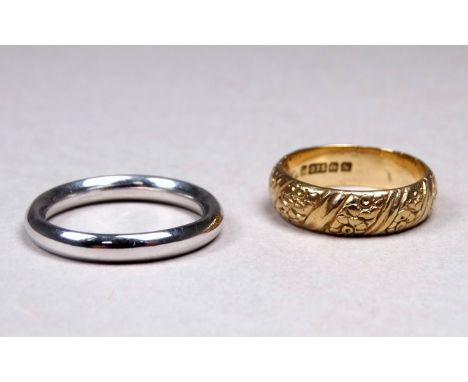 A 9ct white gold wedding band - barrel shaped, size N, weight 3.8g, together with another 9ct yellow gold band, foliate engra