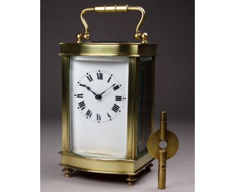 A 20th century carriage timepiece - the case with an ogee front and fitted with a white enamel dial set out in Roman numerals
