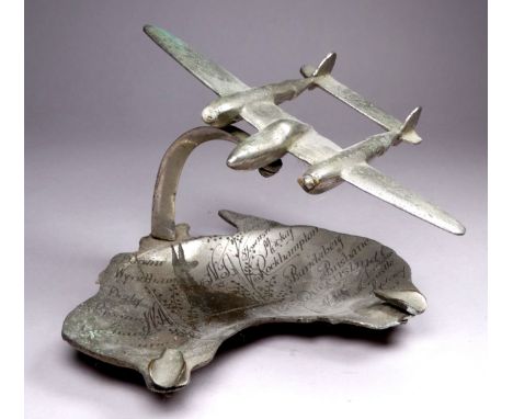 Of aviation interest - a chrome plated ashtray in the form of a twin engine aircraft above a dish shaped as Australia on whic