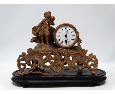 A late 19th century gilt spelter mantel clock - modelled with a vagabond standing beside the white enamel dial set out in Rom