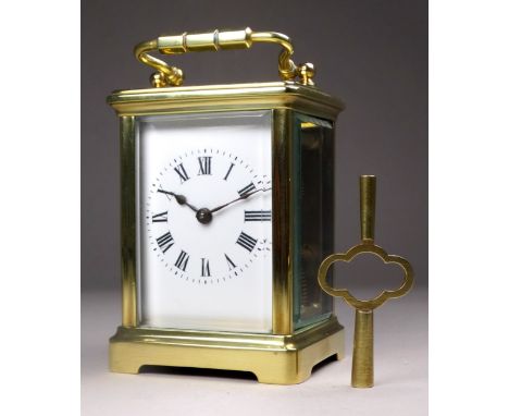 A 20th century carriage timepiece - with a corniche case and white enamel dial set out with Roman numerals, height 10cm.