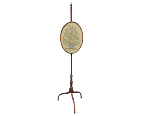 A 19th century mahogany pole screen - with an oval embroidered faceguard on a turned support ending in a tripod base with dow
