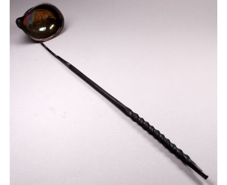 A 18th/19th century white metal punch ladle - the oval bowl with spout, fitted with a contorted baleen handle, length 35cm.