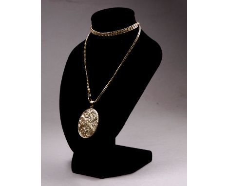 A 9ct yellow gold locket and chain - the oval locket with a foliate engraved cover, on a fine curb-link chain, weight 12.4g.