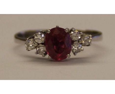 Tested as white gold ring with central ruby (1.0ct) flanked by 6 small diamonds (0.36ct in total), 3.2g, size S