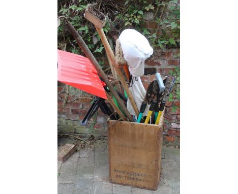 Selection of garden tools in an old tea chest
