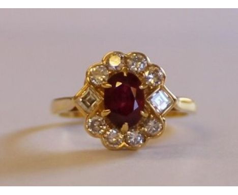 18ct gold ruby and diamond cluster ring with central ruby 0.60ct surrounded by 8 round and 2 square cut diamonds approximatel