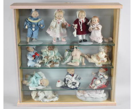 A Glazed Three Shelf Display Cabinet Containing Thirteen Ashton Drake Dolls, 55cm Square 