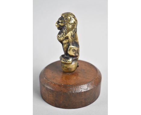 A Vintage Brass Car Mascot in the Form of a Seated Lion Mounted on Turned Wooden Stand, Overall Height 12cms 