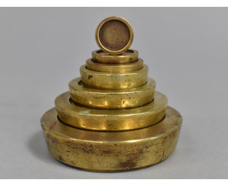 A Set of Seven Graduated Brass Avery Scale Weights 