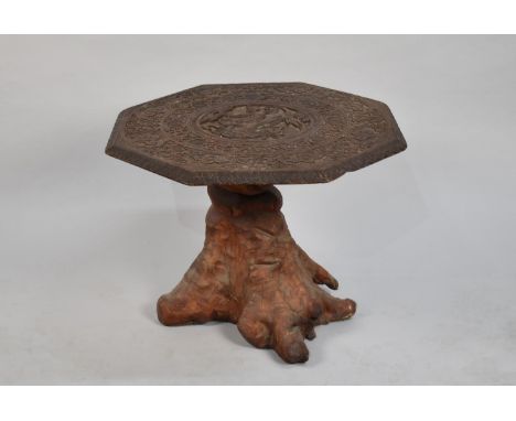 An Intricately Carved Indian Octagonal Table Top Mounted on Tree Trunk Base, 68cms Diameter 