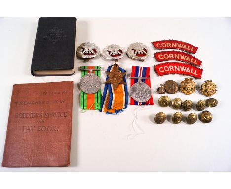 A group of three WWII medals (un-named) in original box, inscribed to Mr K W TRENCHARD, together with badges and buttons for 