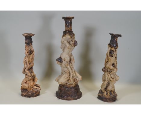 Ron Olley - Three ceramic candlesticks in the form of entwined male and female nudes, one 40cm high, (signed to base) and two