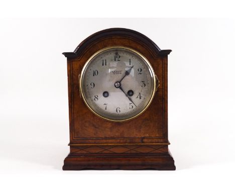 A domed walnut bracket clock by Stewart of Glasgow