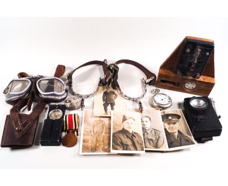 A collection of militaria, including photographs, a pair of spurs, policeman's torch and whistle, swagger stick, compass and 