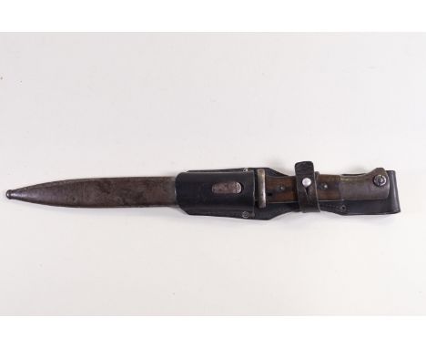 A steel bayonet style dagger with wood handle in a metal scabbard and leather belt fitment, the blade stamped F Herdera  SN  