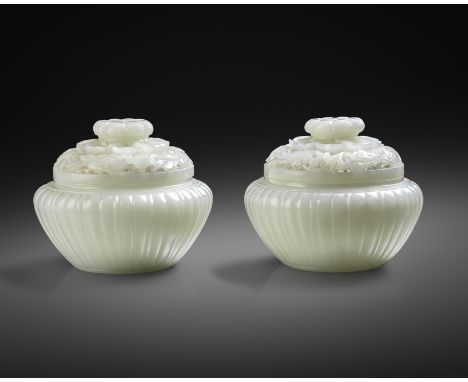 AN EXCEPTIONAL PAIR OF FINE CHINESE IMPERIAL WHITE JADE JARS AND COVERS QIANLONG 1736-95  Each with a fluted body surmounted 