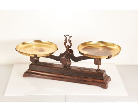 A 20th century set of cast iron weighing scales, probably Americanthe stepped rectangular base with brass dished pans. Cast s